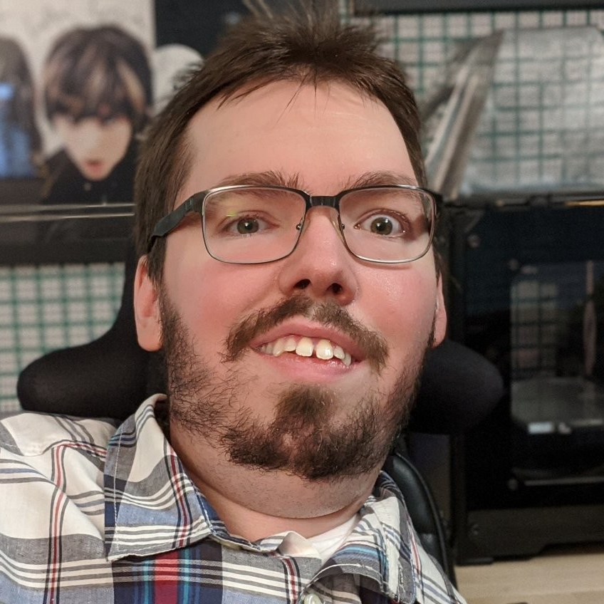 John Porter, wearing glasses and a plaid shirt, smiling at the camera.